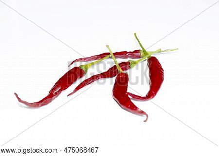 A Lot Of Hot Pepper On A White Background. A Few Chili Peppers On White. Pepper Is Red With Green Ta