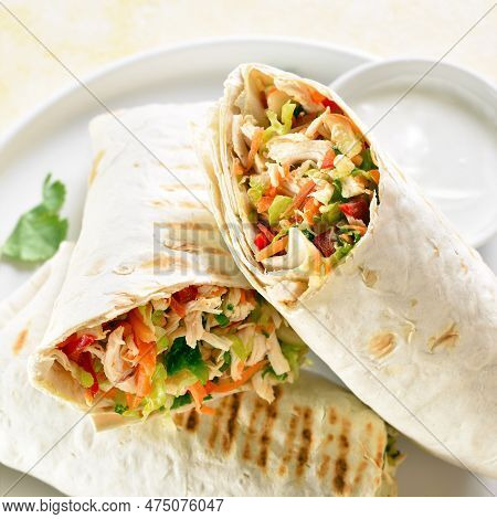 Close Up View Of Tortilla Wraps With Chicken Meat And Fresh Vegetables On Plate.
