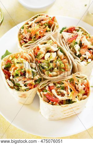 Tortilla Wraps With Chicken And Fresh Vegetables On Plate Over Light Background. Close Up View