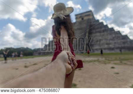 Couple Holding Hands At Mayan Ruins In Mexico. Girl Carrying Boyfriend To Mexican Temple Of Chichen