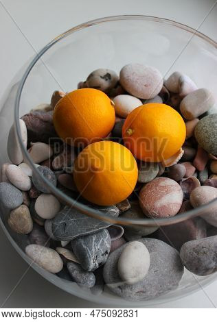 Round Fishbowl With Sea Rocks And Juicy Whole Lemon Fruits On A Windowsill Detailed Stock Photo
