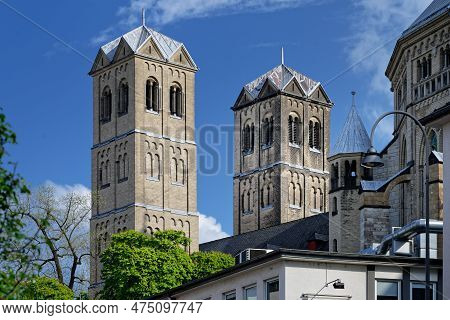 The Two Towers Of The Romanesque Basilica Of St. Gereon In Cologne's Old Town On A Sunny Day Against