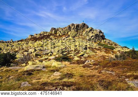 Rocky Mountain Landscape With Blue Sky In The Background. Man At The Top Of The Violik Peak (labski 
