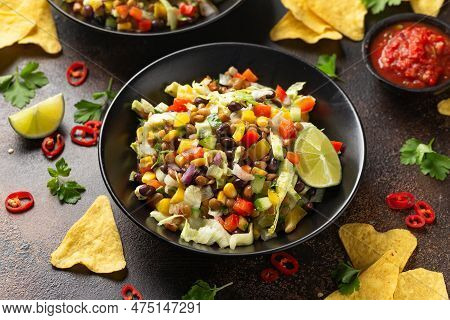 Mexican Style Salad Of Black Beans, Lentils, Corn, Tomato And Lettuce With A Salsa And Tortilla Chip