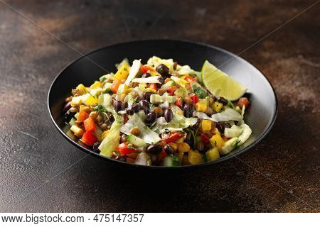 Mexican Style Salad Of Black Beans, Lentils, Corn, Tomato And Lettuce With A Salsa And Tortilla Chip