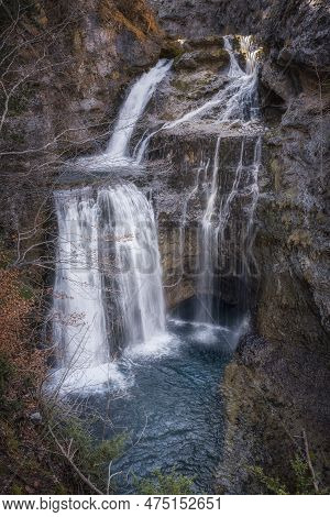 Waterfall The Cave In The Heart Of The National Park Of Ordesa And Monte Perdido, Set In A Rocky Can