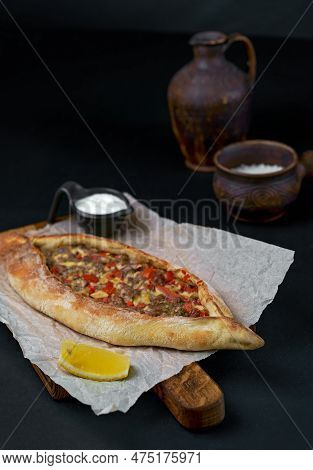 Traditional Georgian Pastry - Adjarian Khachapuri With Cheese And Vegetables Khachapuri On A Wooden 