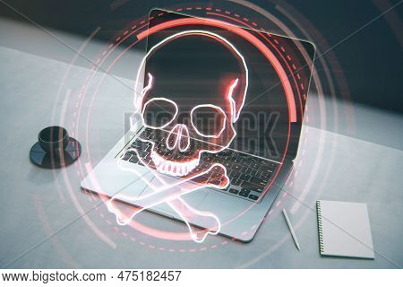 Close Up Of Laptop, Notepad And Coffee Cup On Desktop With Digital Red Skull On Blurry Background. R