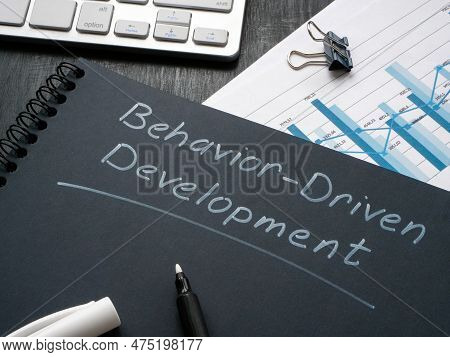 Desk With Notepad And Marks About Behavior Driven Development Bdd.