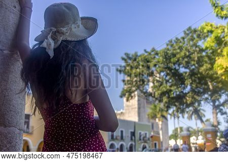 Woman With Hat Enjoying The Mexican City Of Valladolid, Looking At The Cathedral Of San Servacio In 