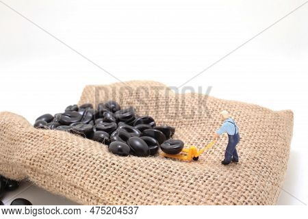 A Worker Using Pallet Jack To Lift Heavy Roasted Coffee Bean