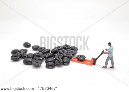 A Worker Using Pallet Jack To Lift Heavy Roasted Coffee Bean