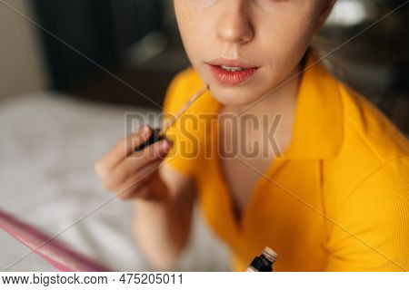 Closeup High-angle View Of Unrecognizable Young Woman Applying Foundation On Face To Correct Skin An