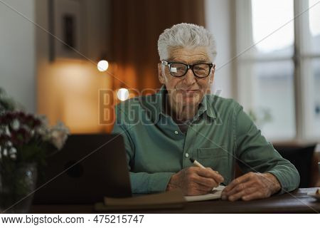Senior Man Writing Notes In His Diary.