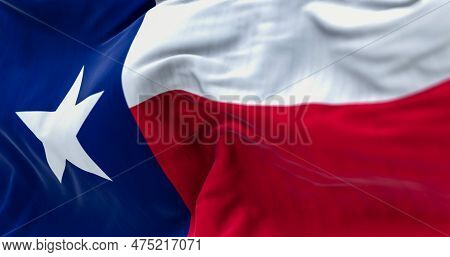 The Texas State Flag Fluttering In The Wind. Blue Vertical Stripe With White Star, White And Red Hor