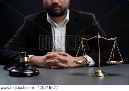 Focus Symbols Of Justice, Gavel Hammer And Scale Balance On Blurred Background Of Thoughtful Lawyer 