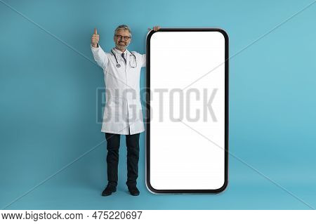 Friendly Middle Aged Doctor Recommending Nice Telemedicine App, Mockup