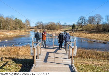 Tourists Admiring The Confluence Of The Rivers Brigach And Breg, Which Forms The Beginning And Origi