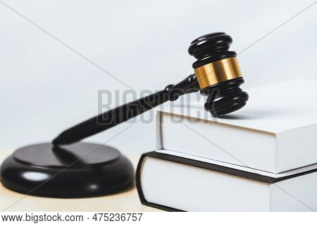 Closeup Wooden Gavel Hammer And Law Book In Empty Law Firm Or White Lawyer Office Background As Just