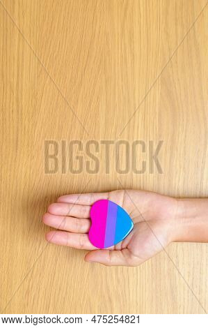 Bisexuality Celebrate Day And Lgbt Pride Month,  Lgbtq+ Or Lgbtqia+ Concept. Hand Holding Purple, Pi