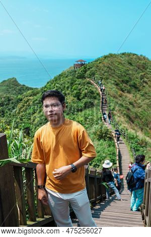 Man Traveler Visiting In Taiwan, Tourist Sightseeing In Bitou Cape Hiking Trail, New Taipei City. La