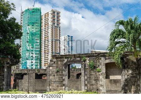 Fort Santiago,ruins With Modern Buildings In The Background,intramuros,manila,the Philippines.