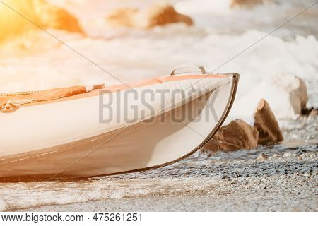 Happy Couple Kayaks In An Inflatable Kayak On The Sea At Sunset. Couple Kanoeing In The Sea Near The