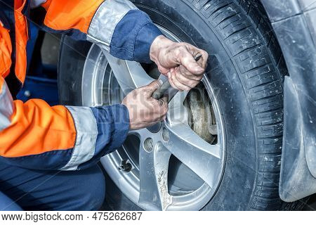 Car Wheel Replacement. Self-service Tire Fitting Concept. Installing A New Wheel. Winter And Summer 