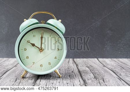Vintage Retro Alarm Clock Ten Time O'clock On Table Wood With Dark Background.