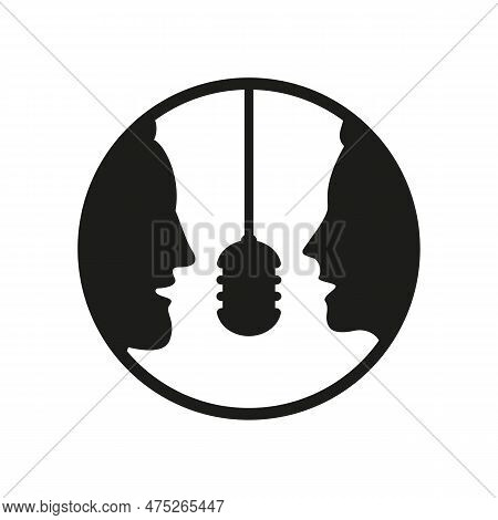 A Man And A Woman Speak Into A Microphone.