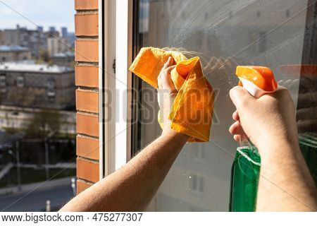 Cleaning Open Home Window Glass In High-rise City House On Sunny Spring Day