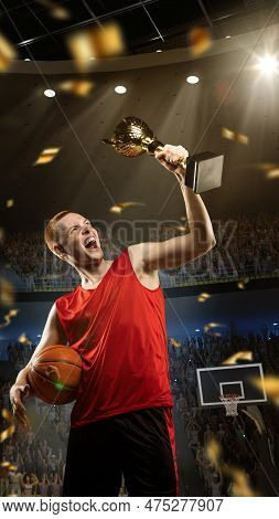 Vertical Image Of Happy, Excited Young Man, Professional Basketball Player In Red Uniform Holding Tr