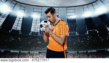 Man, Professional Football Sportsman In Orange Uniform Kissing Ball For Successful Winning Game, Sta