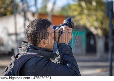 Close-up Of A Photographer Taking A Picture Seen From Behind.