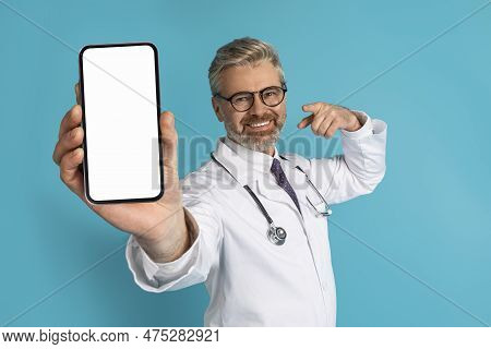 Smiling Grey-haired Caucasian Doctor Showing Phone With Blank Screen