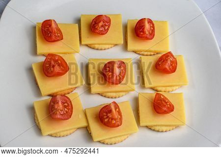Crackers  Served With  Cheese And Tomatoes A