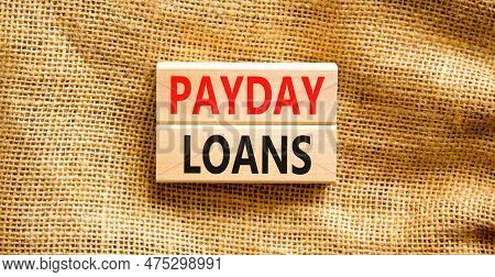 Payday Loans Symbol. Concept Words Payday Loans On Beautiful Wooden Block. Beautiful Canvas Table Ca