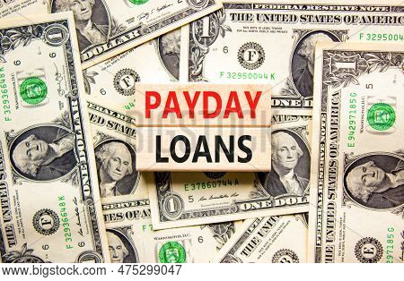 Payday Loans Symbol. Concept Words Payday Loans On Beautiful Wooden Block. Beautiful Background From