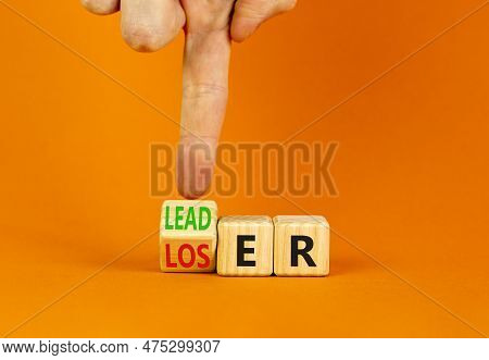 Loser Or Leader Symbol. Businessman Turns Wooden Cubes And Changes The Word Loser To Leader. Beautif