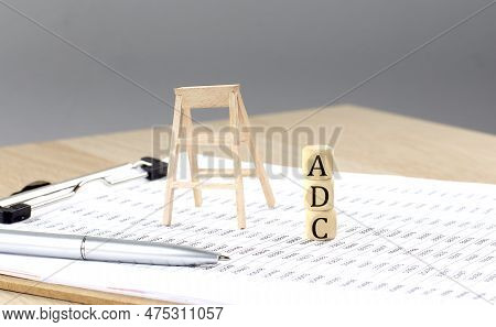 Wooden Cubes With Word Adc Stand On A Financial Background, Business Concept.