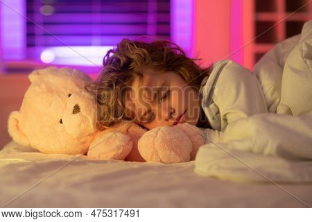 Night Sleep. Kid Sleeps With A Toy Teddy Bear On Bed, Napping. Cute Child Sleeping.