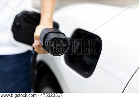 Progressive New Alternative Clean Energy Vehicle And Electric Charging Device Concept. Focus Closeup