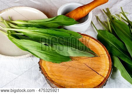 Wild Garlic. Wild Garlic On A Wooden Board On A White Tablecloth.