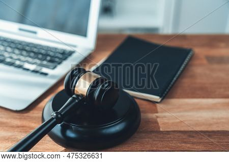 Closeup Wooden Gavel Hammer With Laptop And Book And Pen On Desk On Wooden Office Table Background A