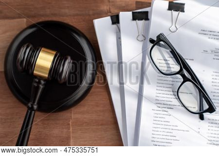 Closeup Top View Black Wooden Gavel Hammer And Legal Document On Wooden Office Desk Background As Ju