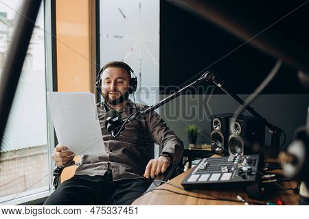 Portrait Of Happy Young Man Working As Radio Host At Radio Station