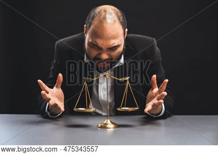 Focus Scale Balance With Blur Lawyer Sitting At His Desk With Worried And Exhausted Expression, Feel