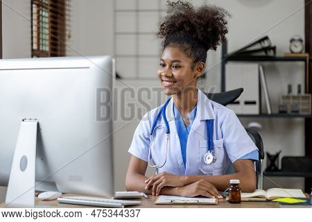 An American Female Doctor Works In A Hospital Office, She Is A General Practitioner And Internal Med