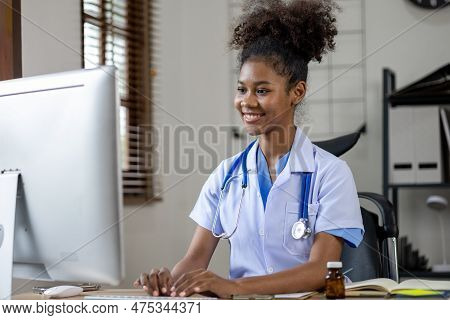 An American Female Doctor Works In A Hospital Office, She Is A General Practitioner And Internal Med
