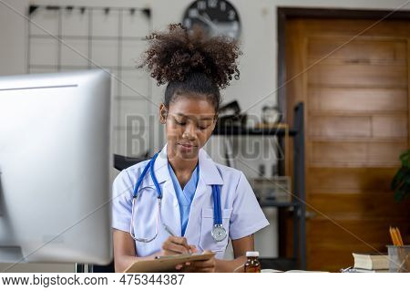 An American Female Doctor Works In A Hospital Office, She Is A General Practitioner And Internal Med